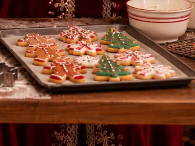 A tray of iced gingerbread men, trees and snowflake cookies