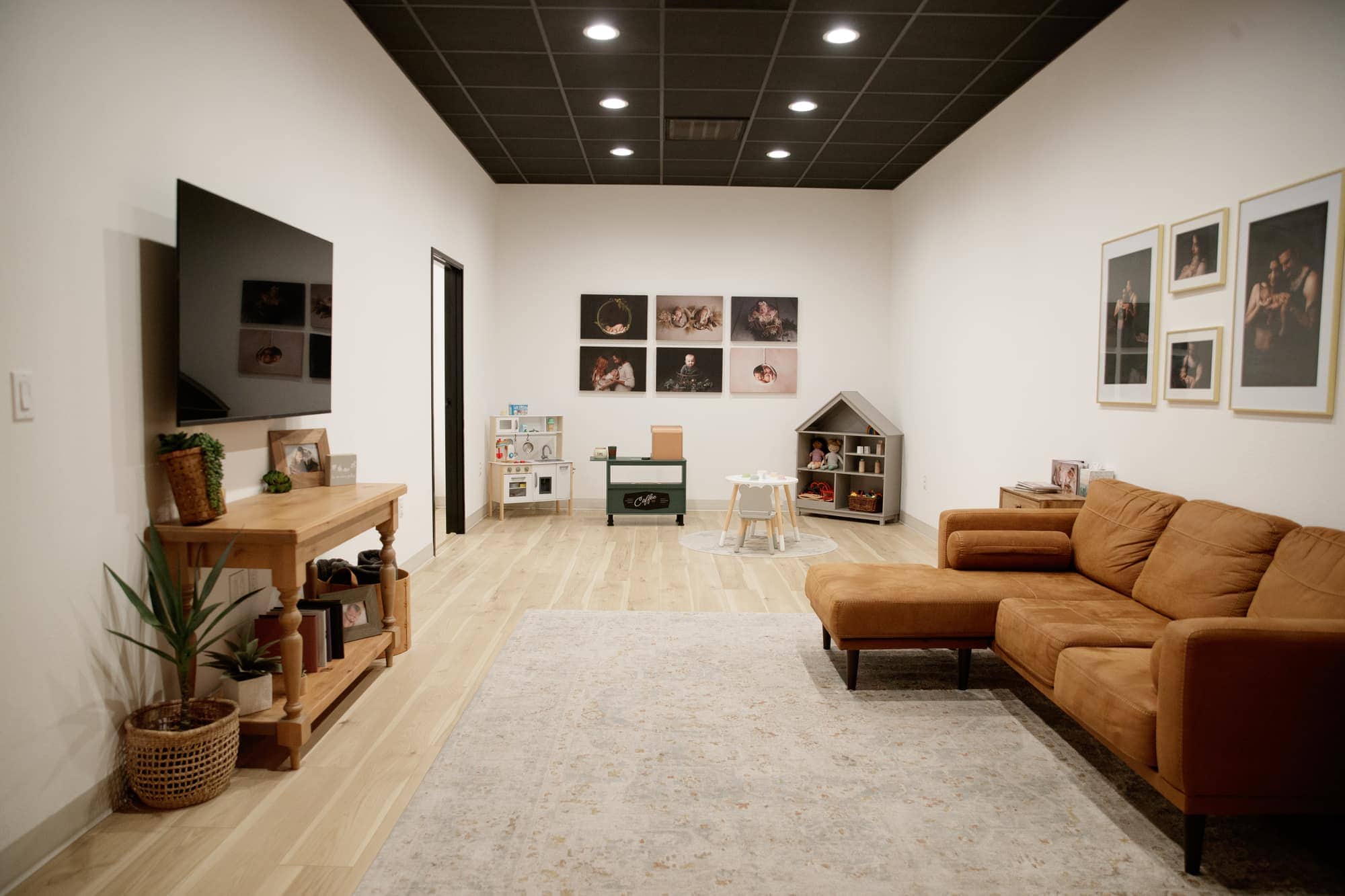 The private family room at Jesica Allen's Lodi photography studio, with a couch, TV and children's play area